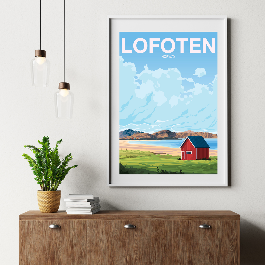 Framed artwork of Lofoten with a red cabin on a wall above a wooden cabinet. The cabin is the classic red rorbu at Ramberg Beach.