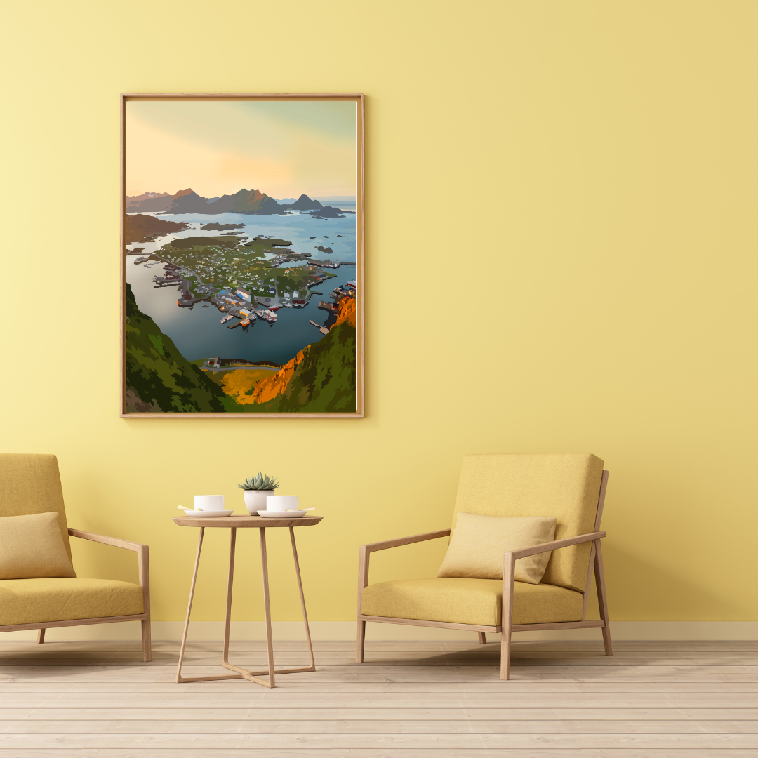 Living room with yellow walls, two chairs, a small table, and a framed landscape painting. The painting has a view over the fshing village Ballstad in Lofoten, Norway.