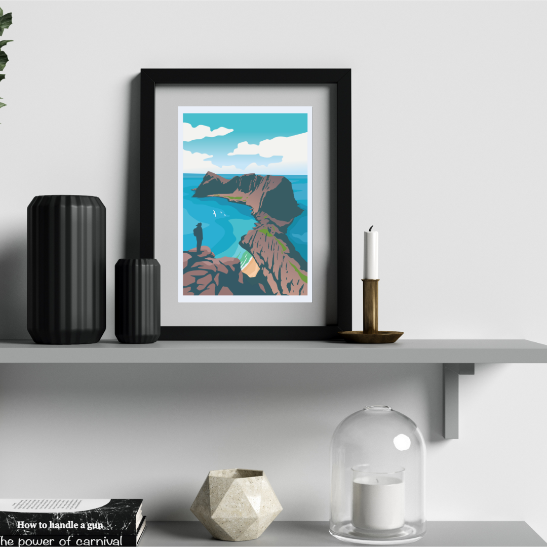 Framed artwork from the top of Håen hike at Værøy in Lofoten, standing on a shelf with decorative items.