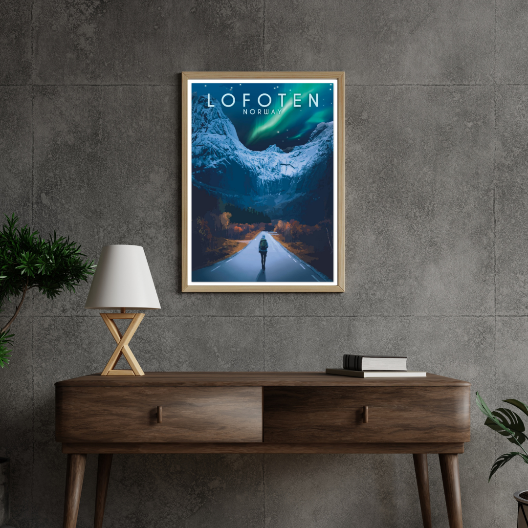 Framed artwork from the Road to Nusfjord, Lofoten, Norway on a wall above a wooden console table. Magical aurora is dancing above the mountains.