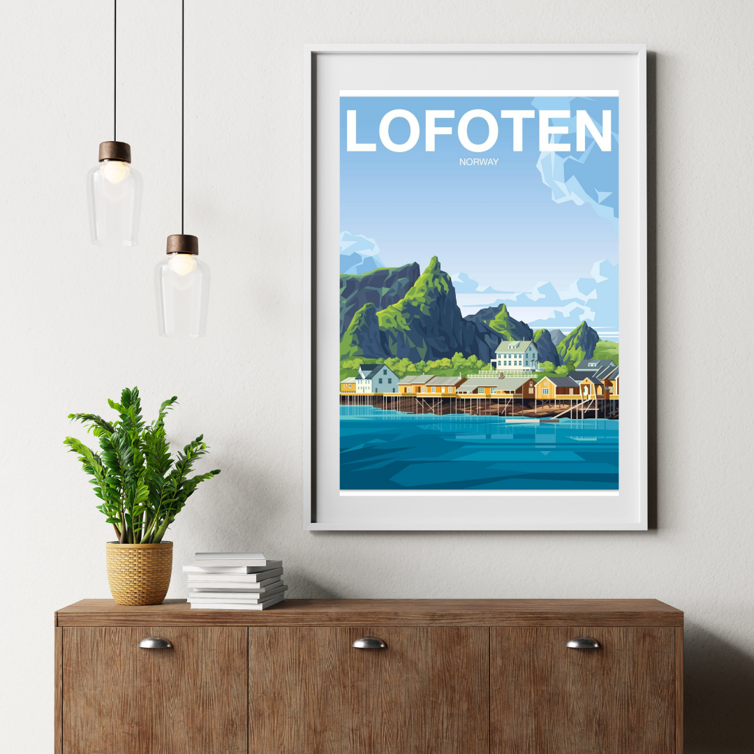 Framed artwork from Sakrisøy in Lofoten, Norway on a wall above a wooden cabinet with a plant and books.