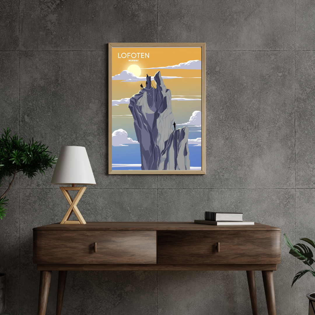 Framed artwork of Svolværgeita climb in Lofoten on a gray wall above a wooden console table.