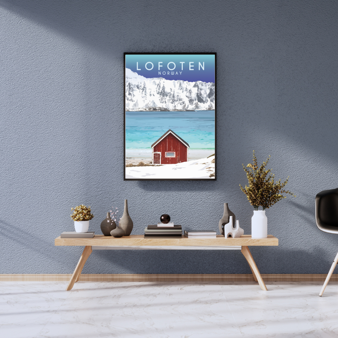Framed artwork from the Ramberg beach in Lofoten, Norway on a wall above a wooden console table with decorative items.