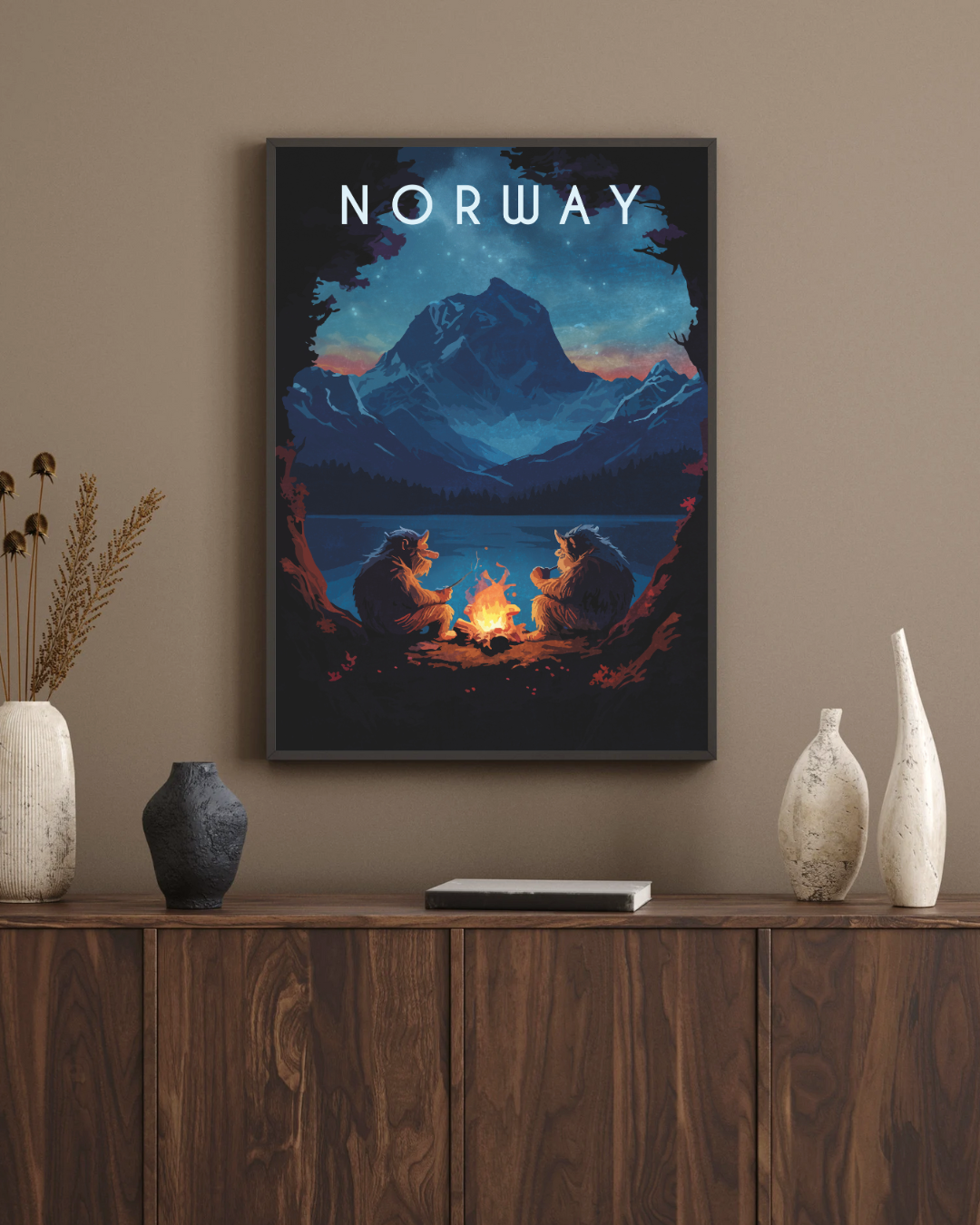 Two trolls are sitting around the fire. Framed picture on a beige wall.