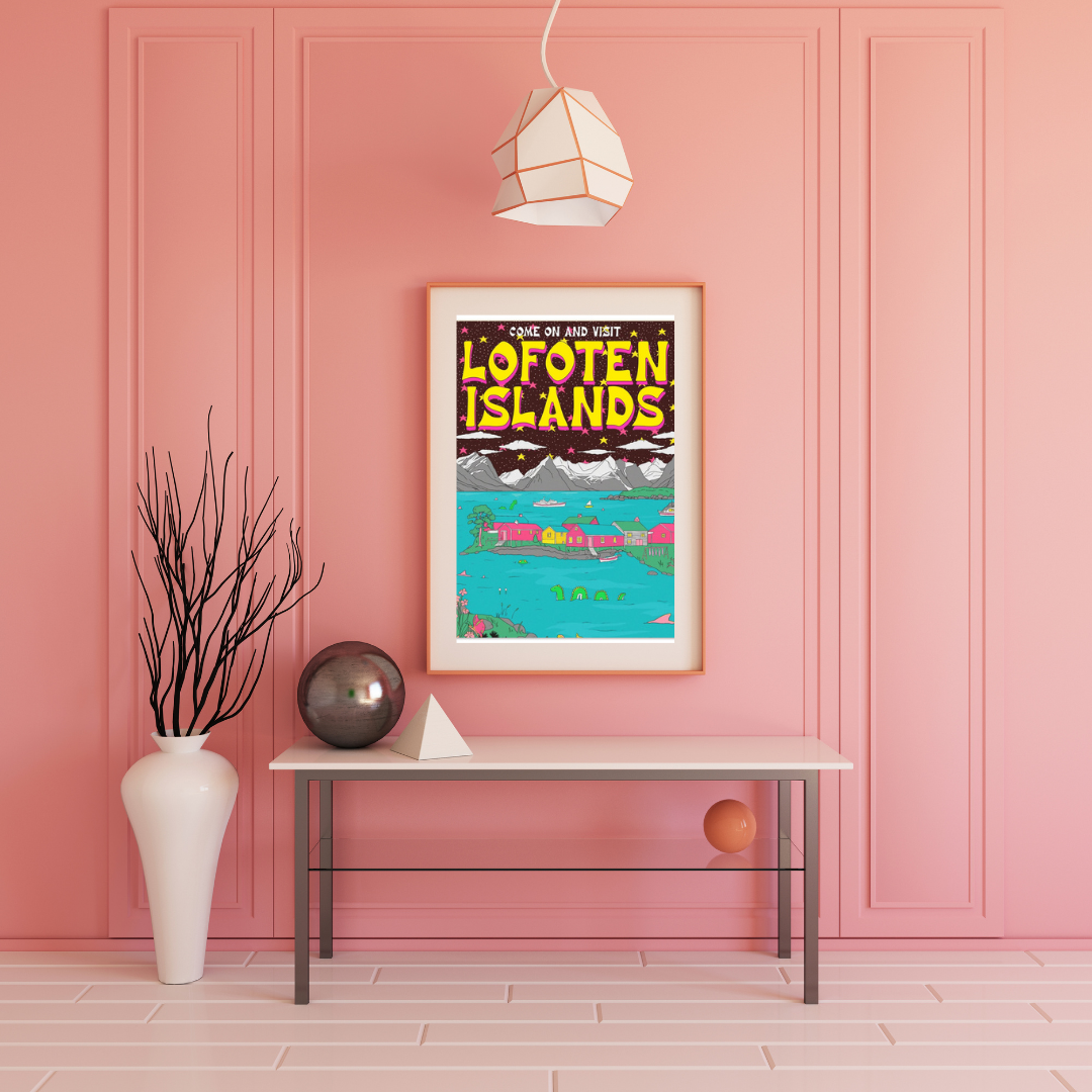 Framed poster of Lofoten Islands on a pink wall with a table and decorative items.