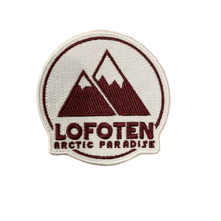 Patch with the text Lofoten Arctic Paradise. A clean logo in white and only two mountains in the background. Two colored, white and dark red.