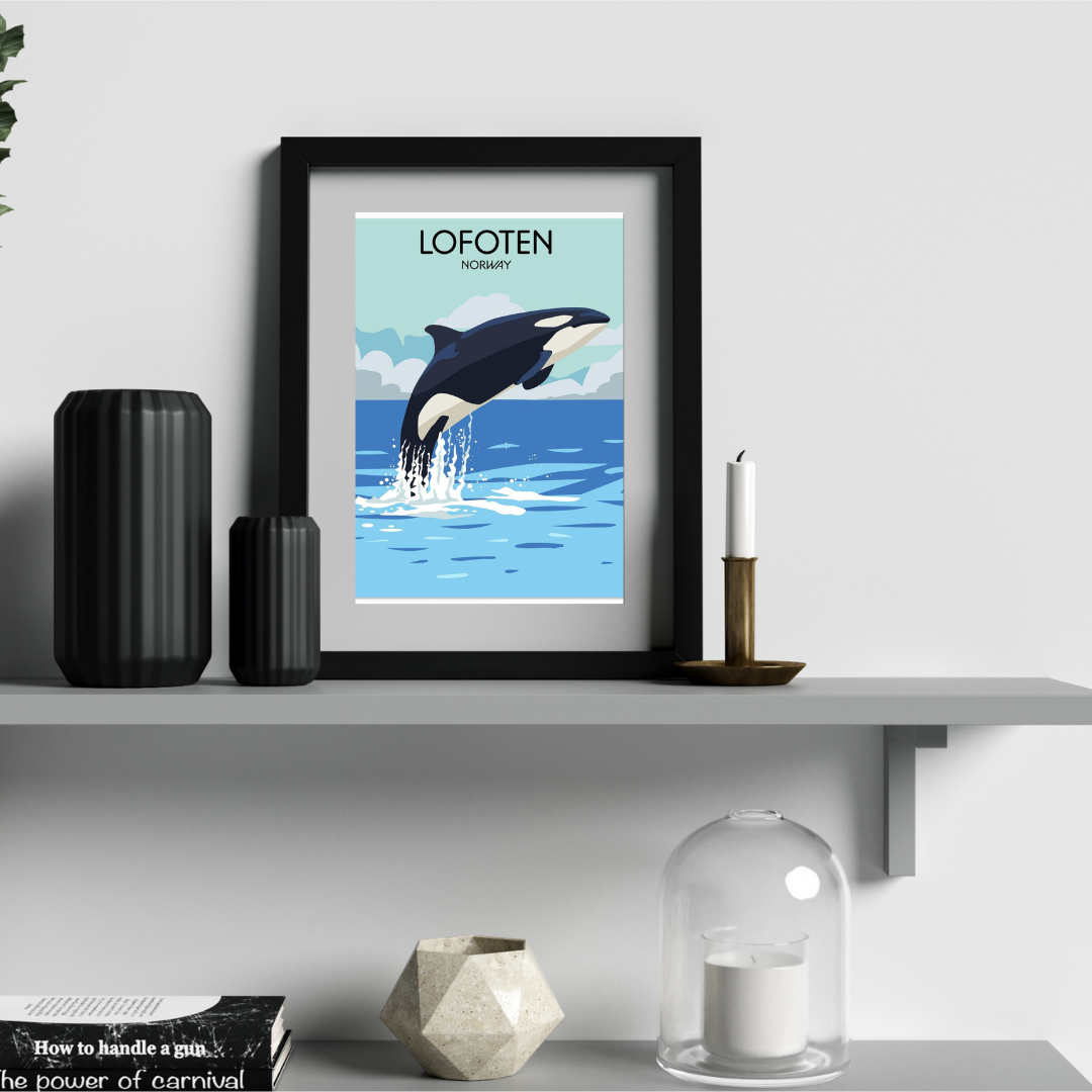 Framed poster of a jumping orca in the ocean with 'LOFOTEN' text on a shelf with decorative items.