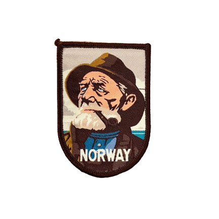 Patch with a Norwegian fisherman. Brown colors and he has a white beard and smoking his pipe. Text says Norway.