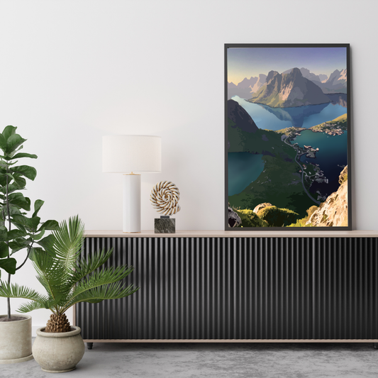 Framed print on a wall above a console table with decorative items. Print is from the top of Reinebringen in Lofoten, Norway. 