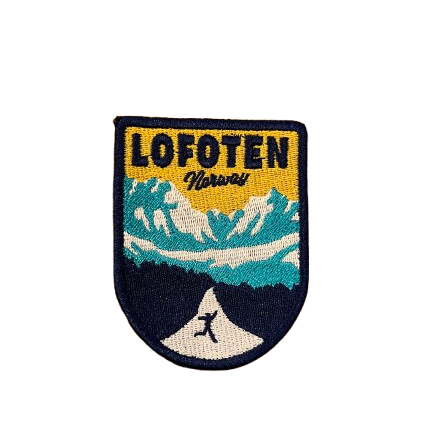 Patch in yellow and blue from the so called Road to Nusfjord in Lofoten. A person is jumping of joy in the middle of the road. 