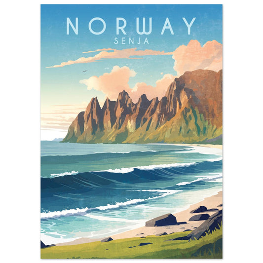 A dramatic mountain range on Senja island, with summer sunlight reflecting off the ocean waves along the rocky coast.